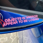 Objects in Mirror Appear to be Losing Car Sticker